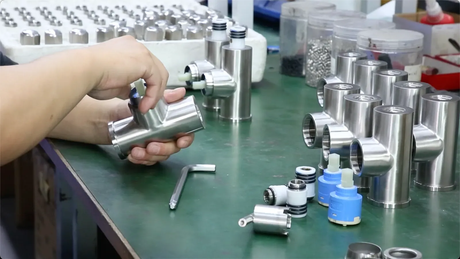 Stainless-steel valve bodies being assembled and checked at the bench